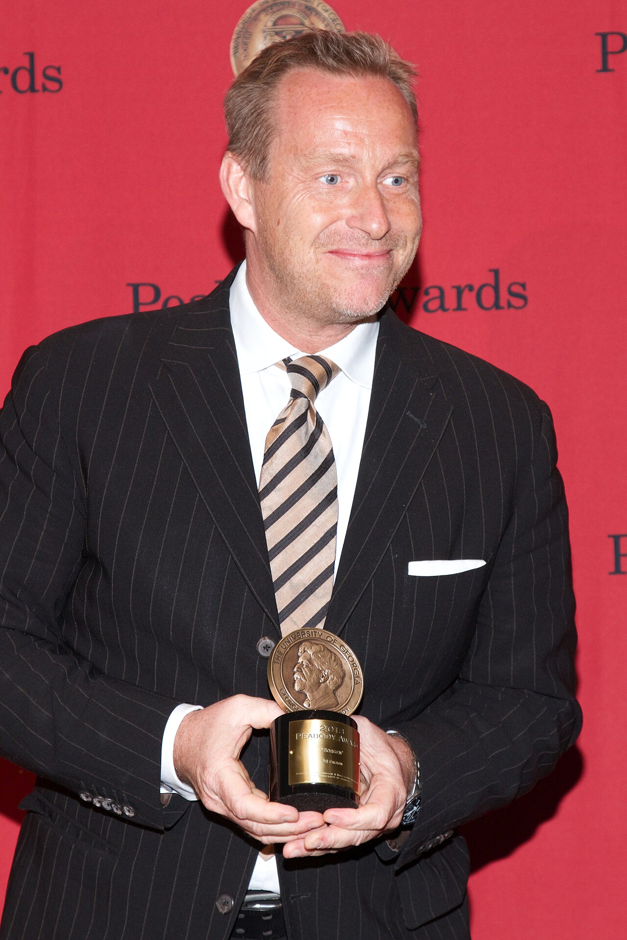Adam Price with a Peabody Award for the television show "Borgen" (2014)