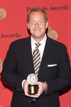 Adam Price with a Peabody Award for the television show "Borgen" (2014)