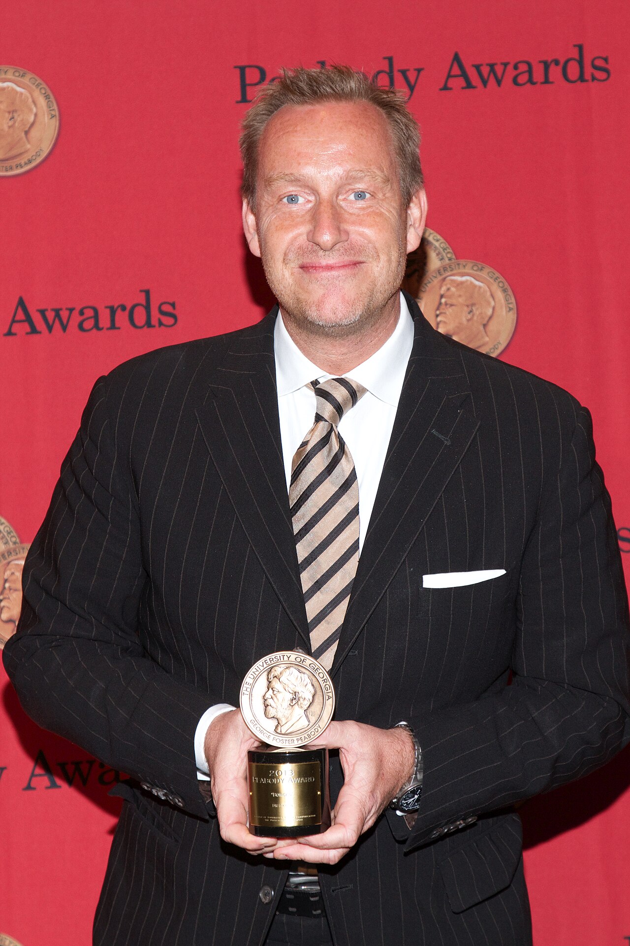 Adam Price with a Peabody Award for the television show "Borgen" (2014)
