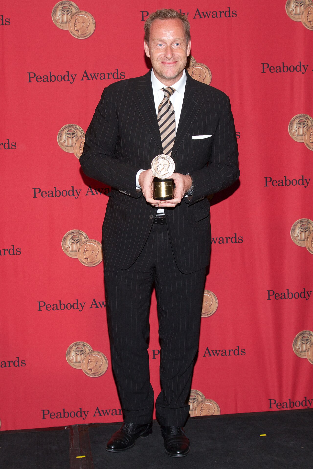 Adam Price with a Peabody Award for the television show "Borgen" (2014)
