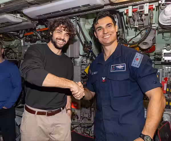 250210-N-GB594-10015 NORFOLK Actor Noah Centineo, from the show "The Recruit", left, poses for a photo with Electrician's Mate (Nuclear) 1st Class Ian Porter ab (2025)