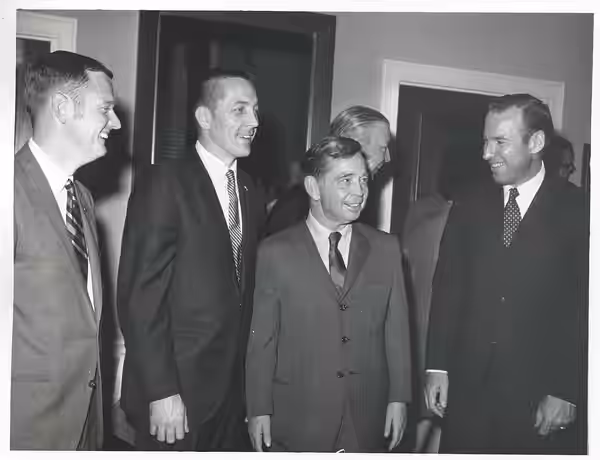 Black and white photograph print of Carl Albert standing with some astronauts.