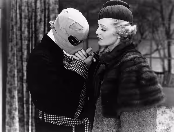 Promotional photo of Claude Rains as Dr. Jack Griffin (The Invisible Man) and Gloria Stuart as Flora Cranley in The Invisible Man (1933).