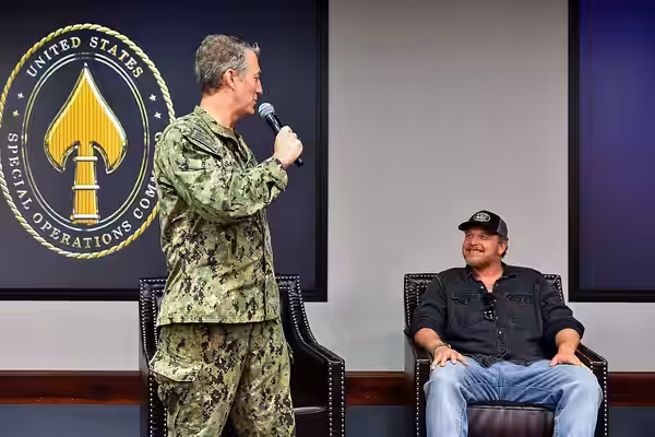 Rear Admiral Milton Sands, U.S. Special Operations Command chief of staff, introduces actor Cole Hauser at a fireside chat for the members of the headquarters,  (2024)