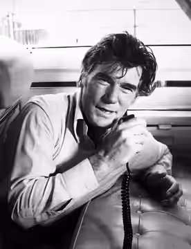 Photo of Mitchell Ryan as Chase Reddick from the television program Chase. In this scene he's doing undercover work from the back seat of a car, staying in touc