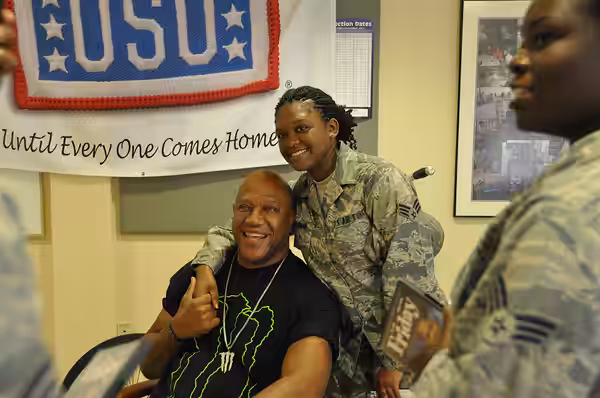 Senior Airman Ronisha Coleman, poses with actor Tiny "Debo" Lister July 12, 2012 at Dover Air Force Base, Del. Lister came to Dover as part of a USO-sponsored v