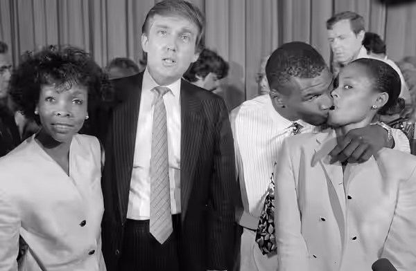 Heavyweight champ Mike Tyson (2nd from R) steals a kiss from his wife Robin Givens (R), while real estate developer Donald Trump and Givens' mother Ruth Roper (