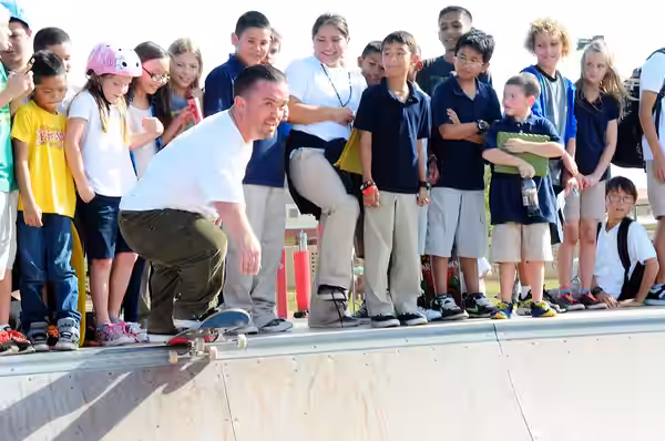Actor Jason “Wee Man” Acuña performs a trick on the half pipe, as Team Andersen youth cheer him on at the skate park on Andersen Air Force Base, Guam, Jan. 9. W (2013)