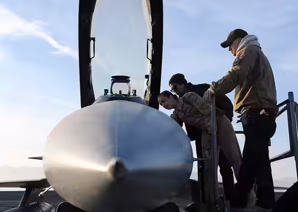 U.S. Air Force 1st Lt. Kaitlin Meiser, an F-16 pilot, shows actors Channing Tatum and Adam Rodriguez the interior of an F-16 Fighting Falcon during a tour at Ba