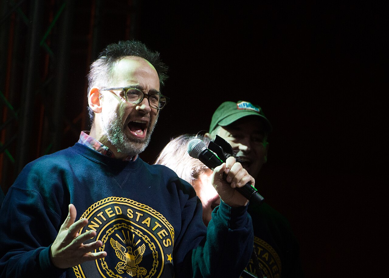 Comedian David Wain sings during the USO show at Naval Support Activity Bahrain, Dec. 7, 2015. The Chairman, along with members of the 2015 USO Entertainment Tr