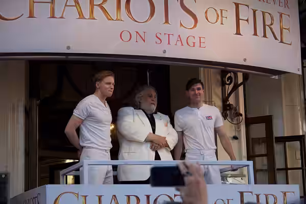 Left to right: Actor Jack Lowden, composer Vangelis, actor James McArdle of the play Chariots of Fire at the London 2012 Olympics torch relay.