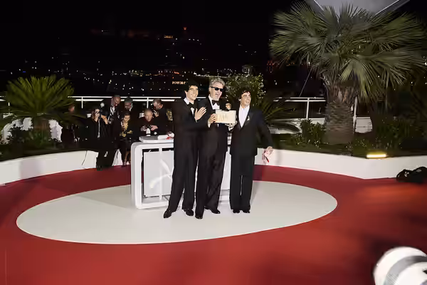 Javier Calvó, Paweł Pawlikowski and Javier Ambrossi pose with the ex-aequo Best Director award for "The Black Ball" and "Fatherland" during the Palme d'Or winne (2026)