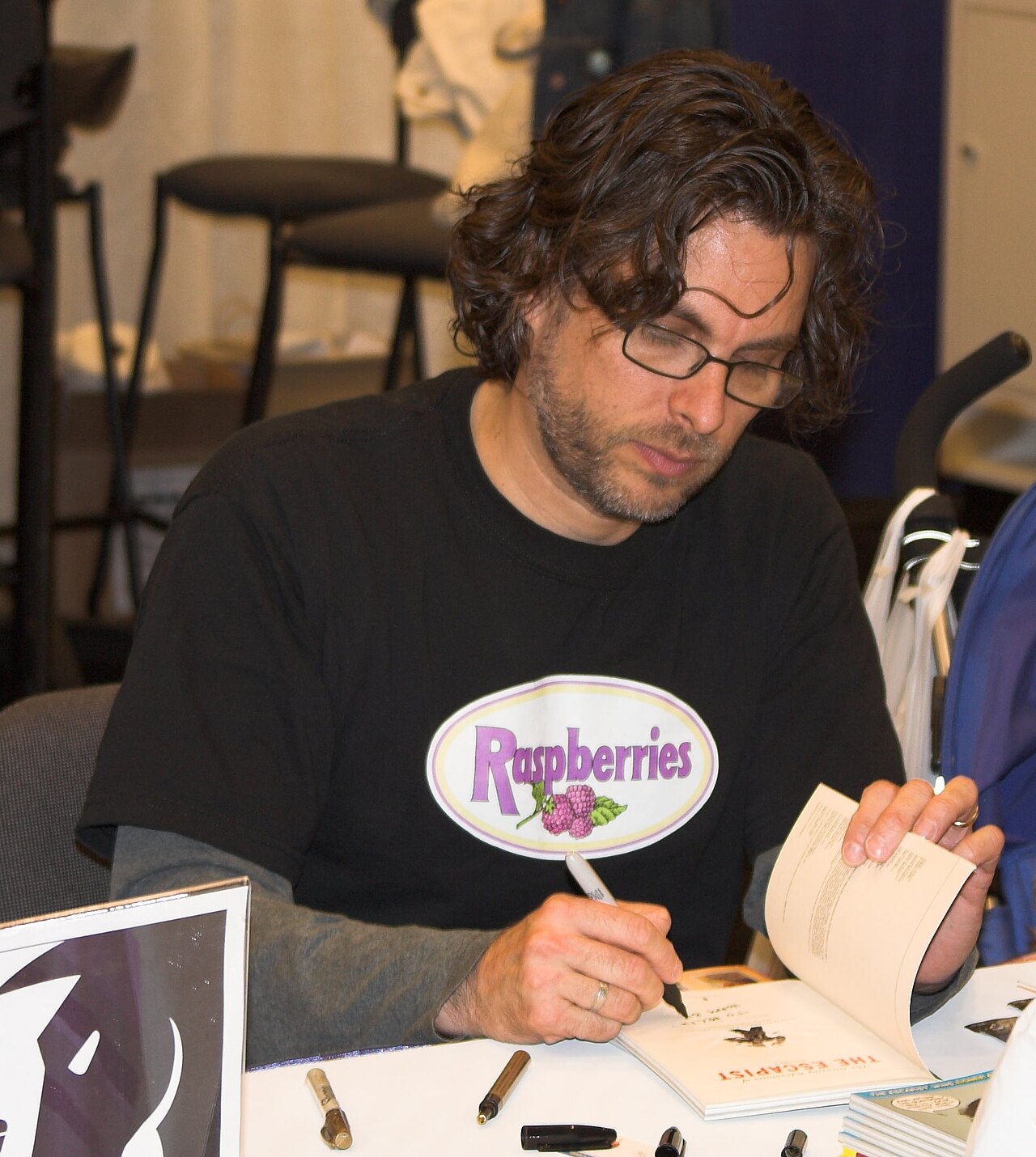 Photograph of author Michael Chabon at a book signing at WonderCon in 2006.