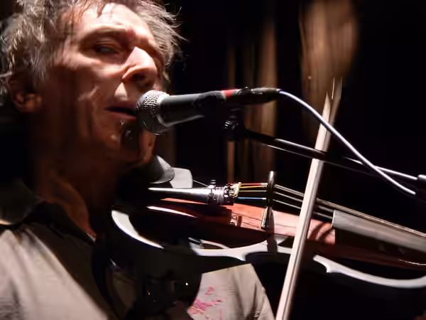 Photo of John Cale playing the viola at a concert in De Warande (club), Turnhout, Belgium (3 February 2006).