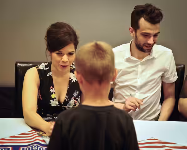 America Ferrara and Jay Baruchel, voices of characters in the new movie “How to Train Your Dragon 2”, sign autographs during a USO tour June 4, 2014, at Joint B