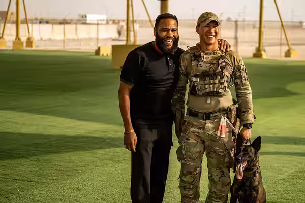 Actor Anthony Anderson poses for a photo with an Airman assigned to the 379th Expeditionary Security Forces Squadron within the U.S. Central Command area of res