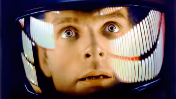 Dr. David Bowman (Keir Dullea) with wide eyes visible through his helmet visor