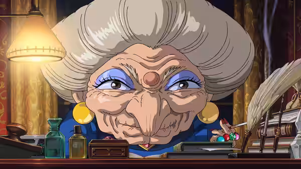 Yubaba seated at her desk with lamp and papers