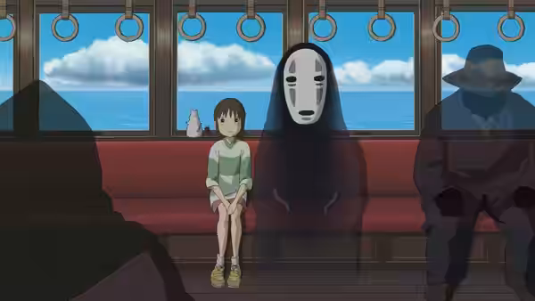 Chihiro seated on a train beside No-Face with ocean views