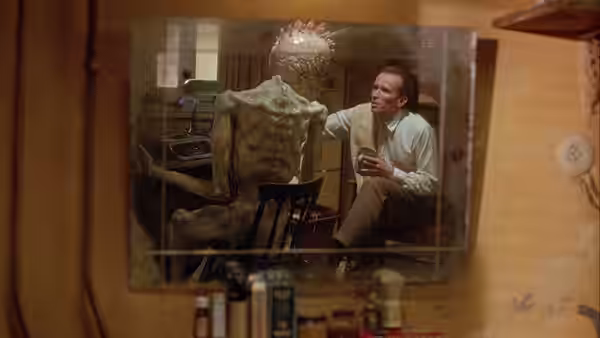 Bill Lee (Peter Weller) talking to a creature at a typewriter
