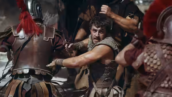 Lucius (Paul Mescal) held by Roman soldiers in battle armor