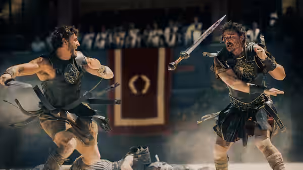 Lucius (Paul Mescal) clashing swords with another gladiator in the arena