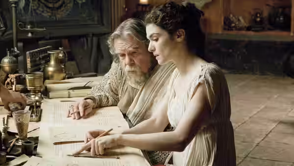 Theon (Michael Lonsdale) and Hypatia (Rachel Weisz) examine a manuscript at a table