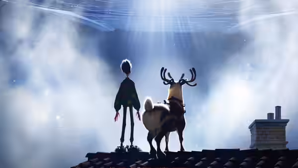 A young man and a reindeer stand on a rooftop beneath a beam of light