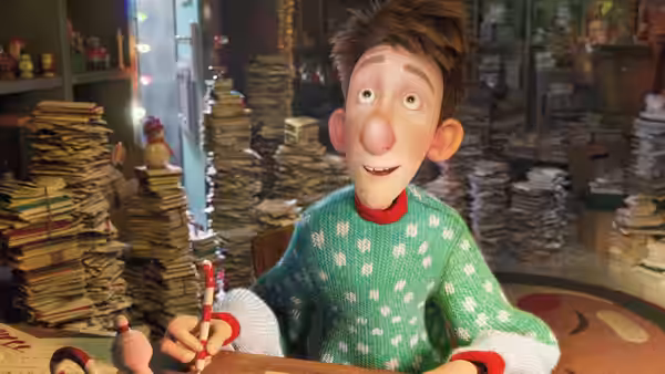 Arthur writes at his desk, surrounded by tall stacks of letters