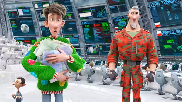 Arthur cradles a baby beside Steve in the North Pole control room