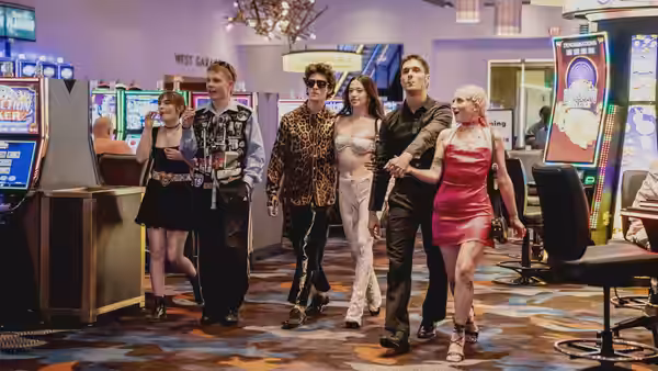 Ivan (Mark Eydelshteyn) and Ani (Mikey Madison) walking through a casino with friends
