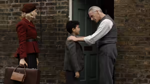 Rita (Saoirse Ronan) and George (Elliott Heffernan) greeted by man at doorway