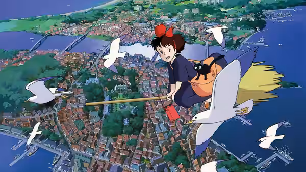 Kiki (Minami Takayama) flying over a coastal town on a broomstick with Jiji