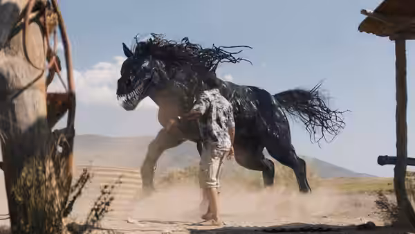 A man faces a symbiote horse rearing up in a desert landscape