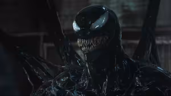 Venom bares sharp teeth and white eyes in close-up