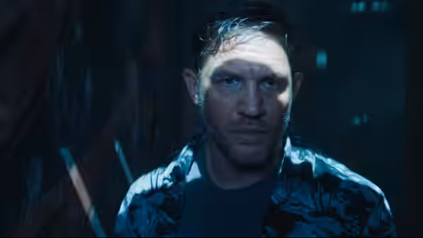 Eddie Brock (Tom Hardy) looks ahead with a serious expression