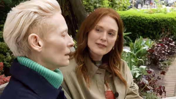 Tilda Swinton speaks to Julianne Moore in a garden setting