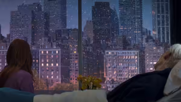 Julianne Moore and Tilda Swinton lie in bed overlooking a city