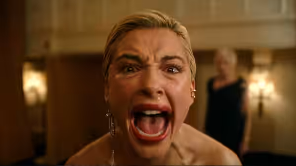 Skye Riley (Naomi Scott) screaming with mouth wide open indoors
