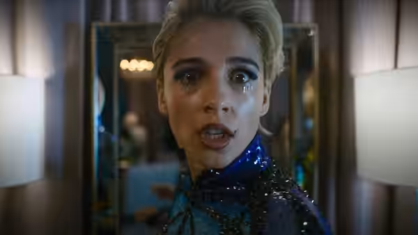 Skye Riley (Naomi Scott) with tears on her face in a blue sequined top