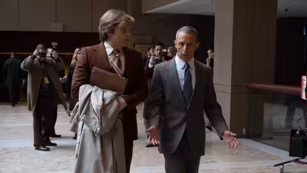 Donald Trump (Sebastian Stan) walks with Roy Cohn (Jeremy Strong) through a building lobby