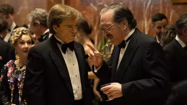 Donald Trump (Sebastian Stan) listens to Roy Cohn (Jeremy Strong) at a formal event