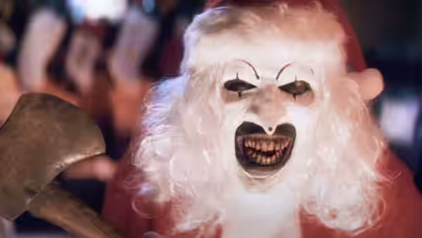 Art the Clown (David Howard Thornton) in a bloody Santa suit holding an axe and screaming