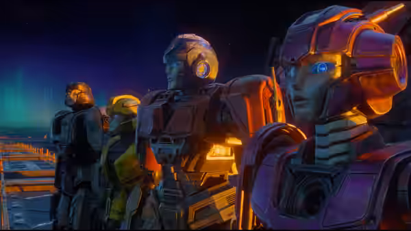 Several robots stand on a platform overlooking a glowing night landscape