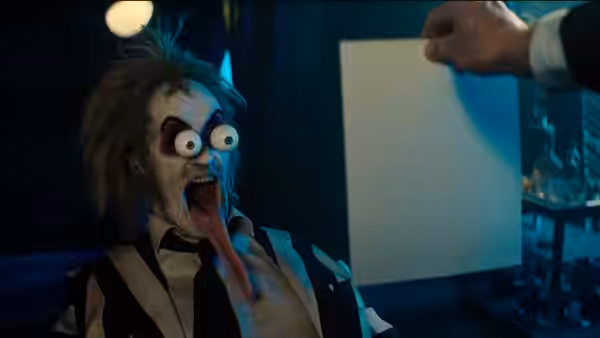 Beetlejuice (Michael Keaton) with wide eyes and tongue extended outward