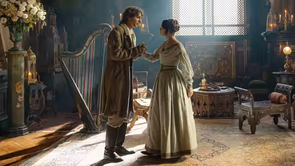 Pierre Niney as the Count stands holding hands with a woman in a grand hall