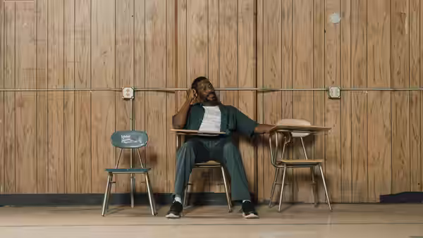 John 'Divine G' Whitfield (Colman Domingo) reclines at a desk in an empty room