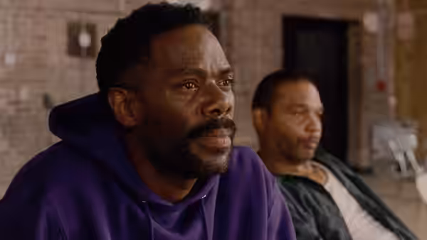 John 'Divine G' Whitfield (Colman Domingo) sits in a purple hoodie looking aside