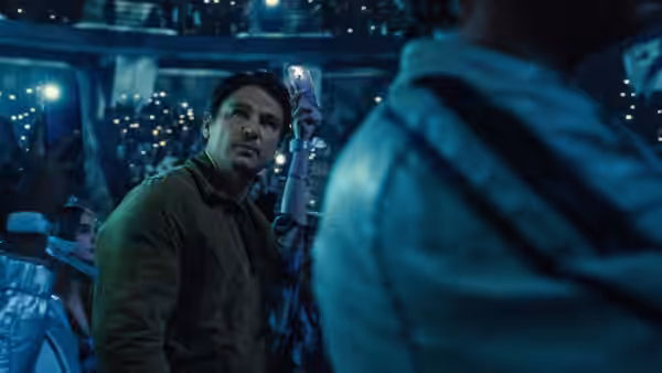 Cooper (Josh Hartnett) looking ahead in a crowded concert space at night