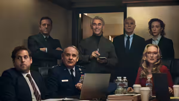 Peter Isherwell (Mark Rylance) addresses officials and military officers at a briefing table